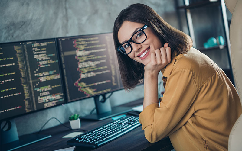 Smiling woman working at PC Smiling woman working at PC