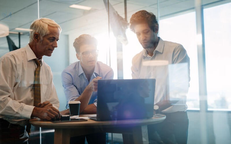 Business men collaborating over table