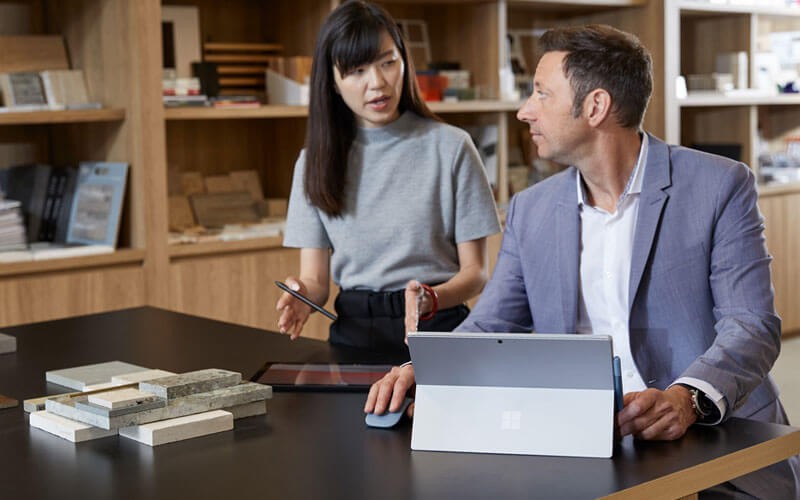 Business colleagues using a Surface Pro 7