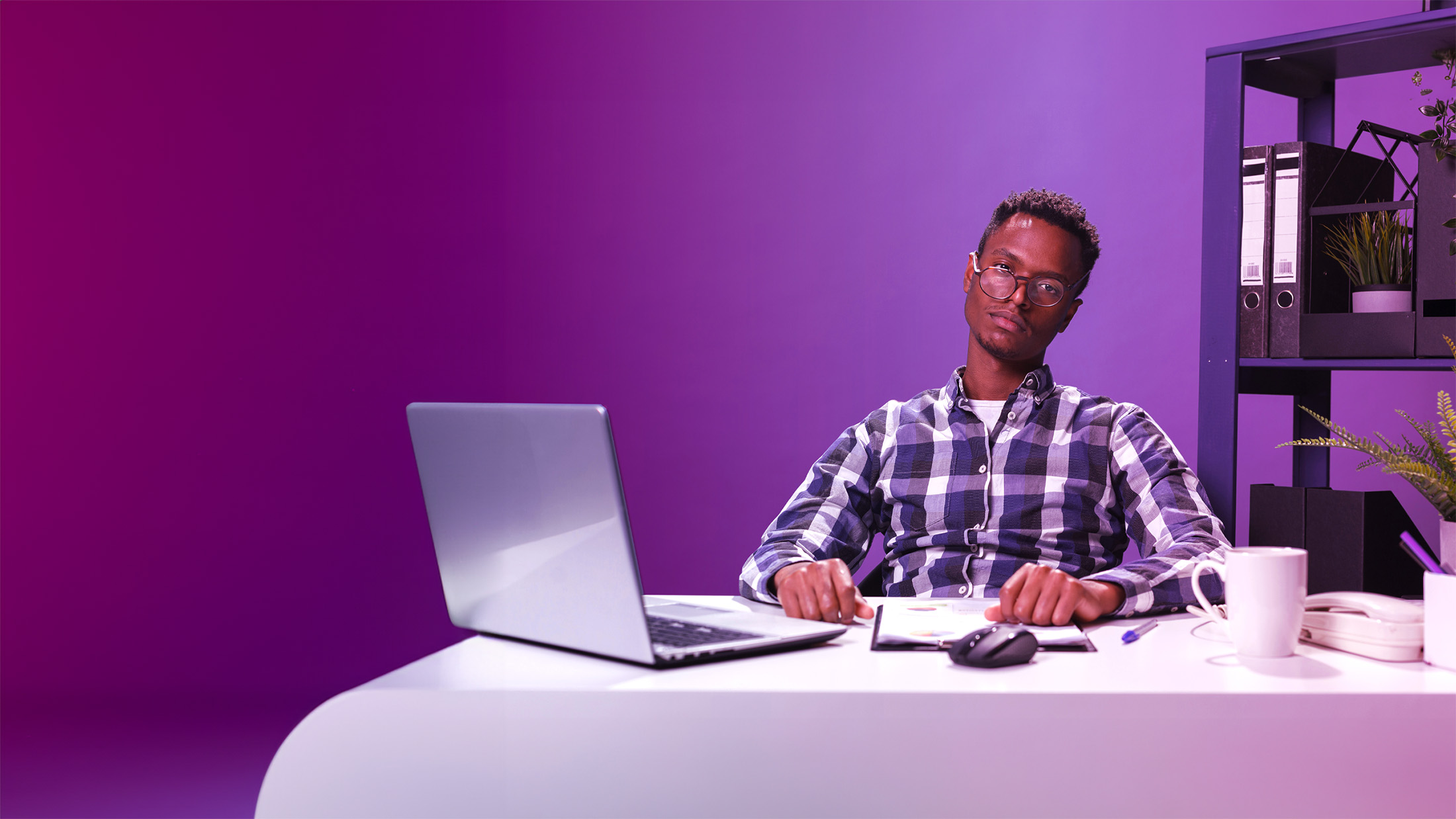 man looking fed up at a laptop