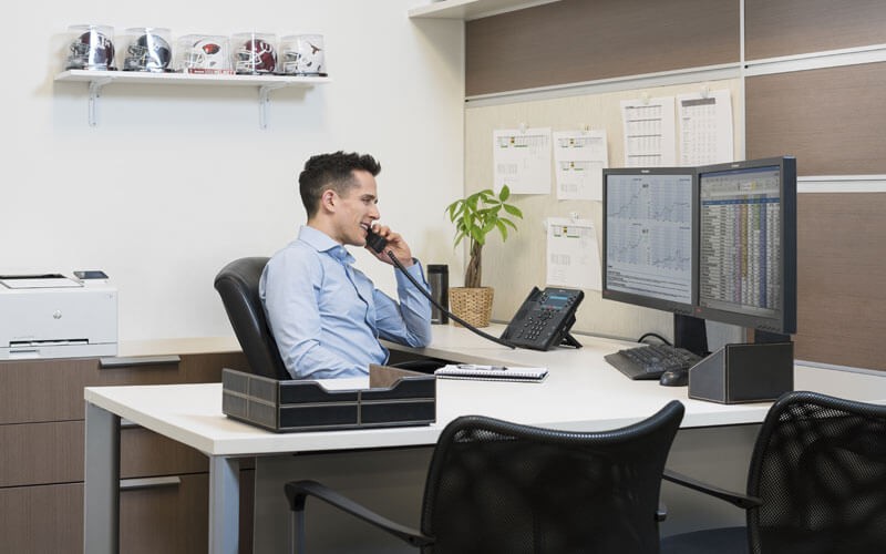 Business man using Poly telephone