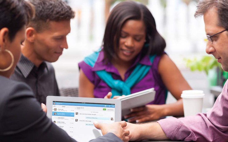 Apple and Cisco are bringing intuitive end-user experiences Group of colleagues using Apple devices