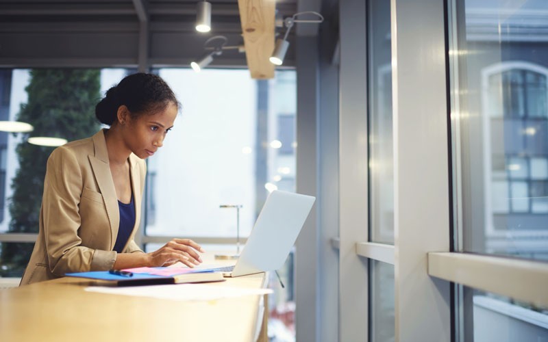 Woman working remotely on laptop device