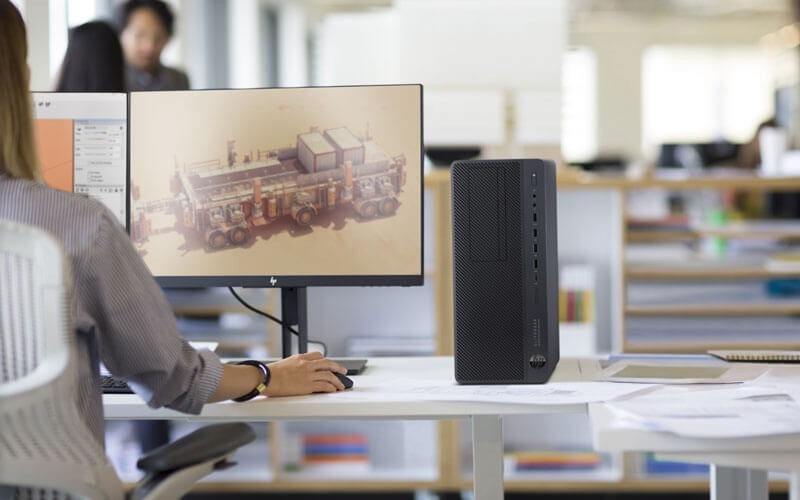 Woman using HP microtower PC