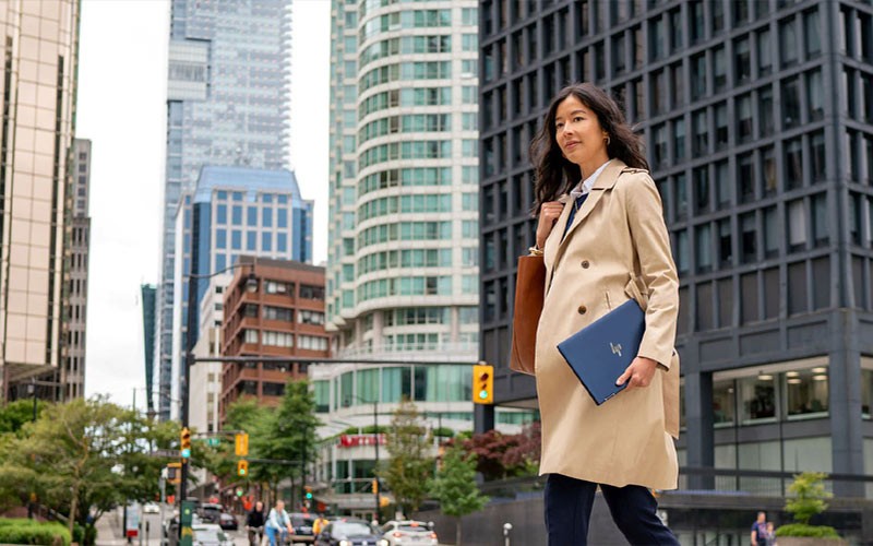 Business woman holding HP convertible notebook