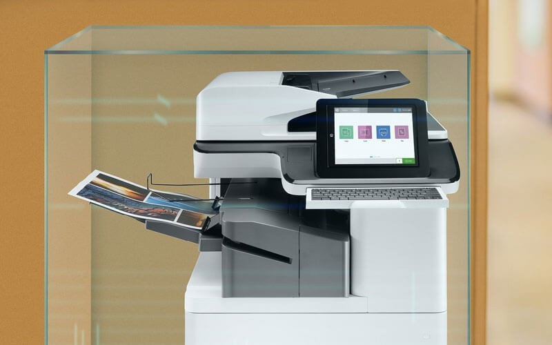 HP Colour LaserJet Pro MFP M377dw on a cart in an office.