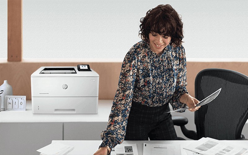 woman picking up printed documents
