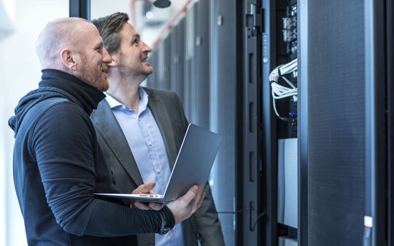 IBM storage solutions Two men checking servers